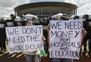 Activists demonstrate in front of riot police outside the Mane Garrincha National Stadium in Brasilia